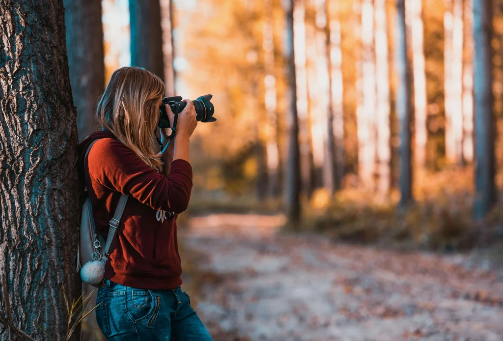 Female photographer using a travel camera: Best cameras for professional photographers capturing moments on the go."