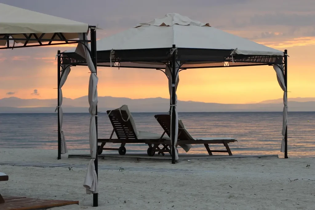  A family going to the beach sets up a beach tent for shade and relaxation.