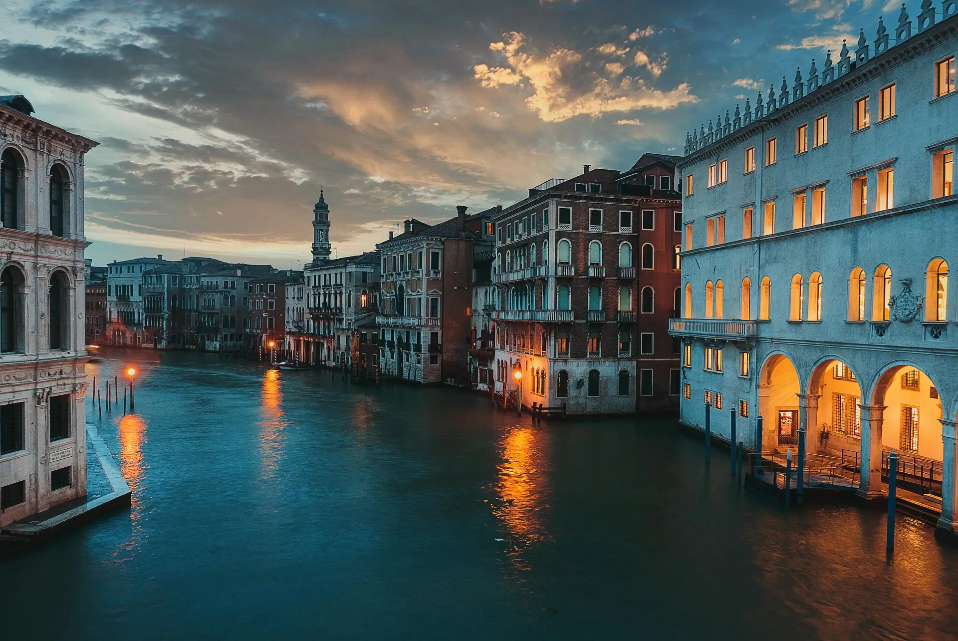 A scenic view of a canal in Venice, Italy, showcasing traditional gondolas and historic architecture, ideal for travelers seeking cultural experiences in February.