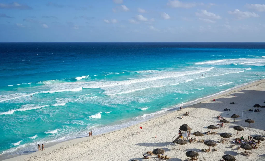 A stunning beach in Cancun, Mexico, with turquoise waters and white sand, highlighting one of the best places to travel in March.