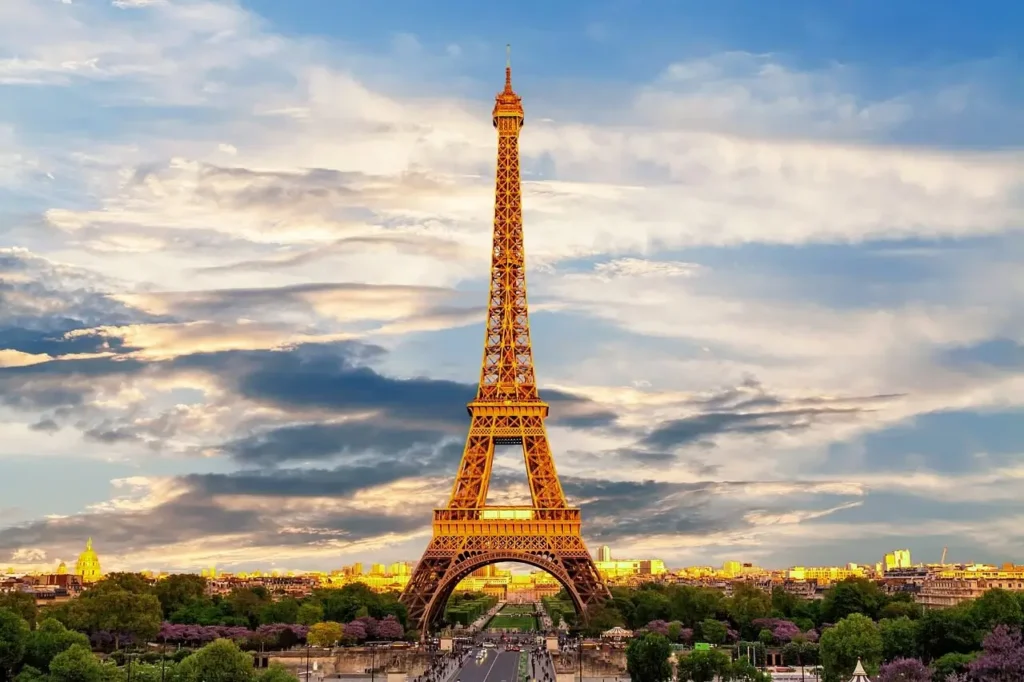 The Eiffel Tower in Paris, France, viewed from a low angle against a clear blue sky.