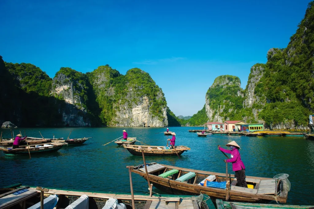 "Aerial view of Ha Long Bay in Vietnam, showcasing its limestone karsts and emerald waters—one of the amazing Asian places to travel."