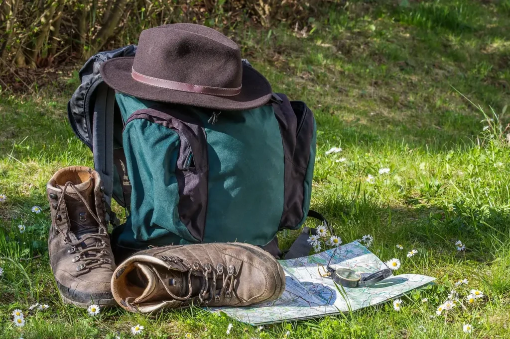 Hiker using map while wearing walking boots in the wilderness