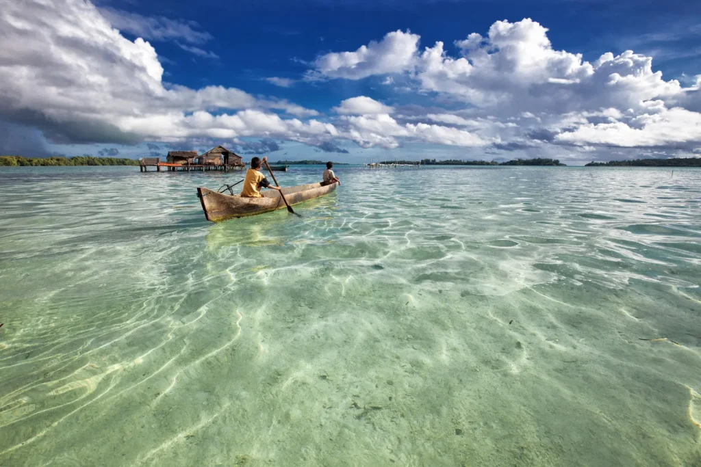 "Amazing Asian places to travel: tranquil lagoon reflecting clear blue skies."