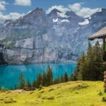 Serene mountain lake with a cozy hut, ideal for February travel in the USA