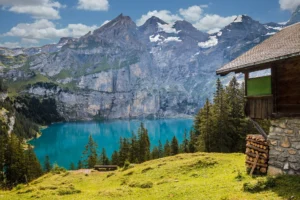 Serene mountain lake with a cozy hut, ideal for February travel in the USA