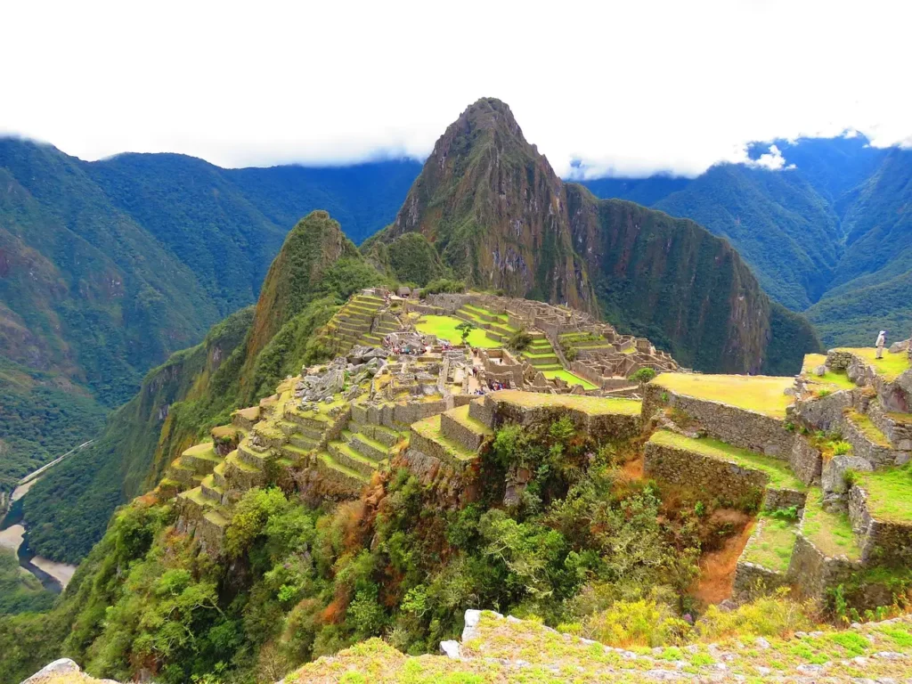 Machu Picchu in Peru, one of the best places to travel in March, featuring clear skies and lush green landscapes.