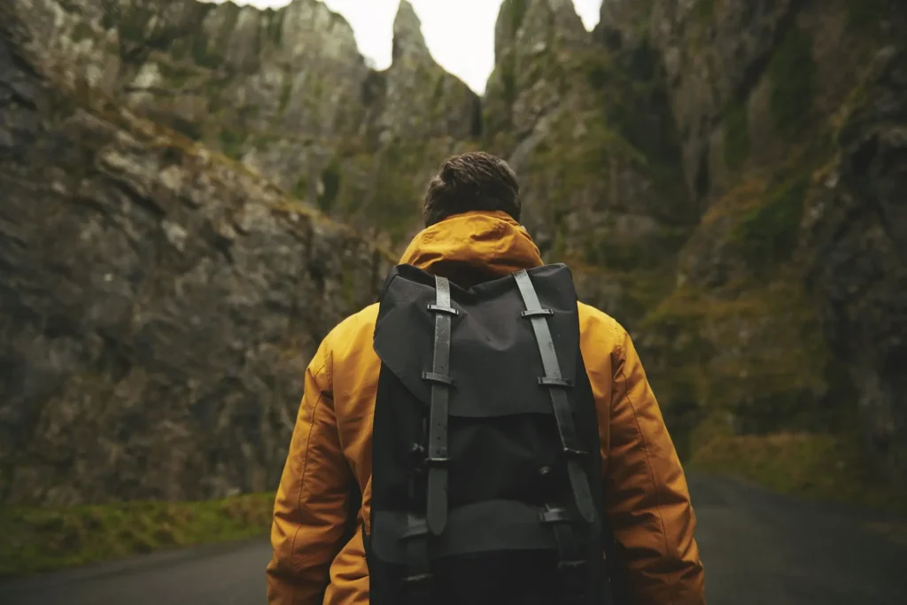 Man with adventure backpack walking in nature