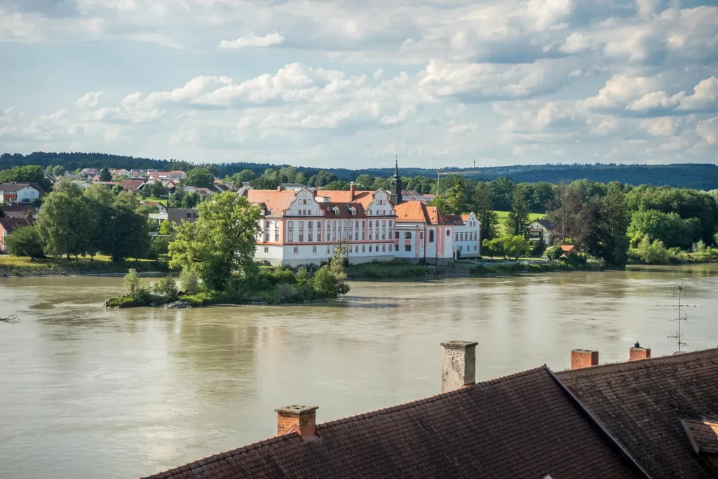 "A beautifully restored historic monastery, now serving as a travel inn, showcasing its architectural grandeur and serene surroundings.