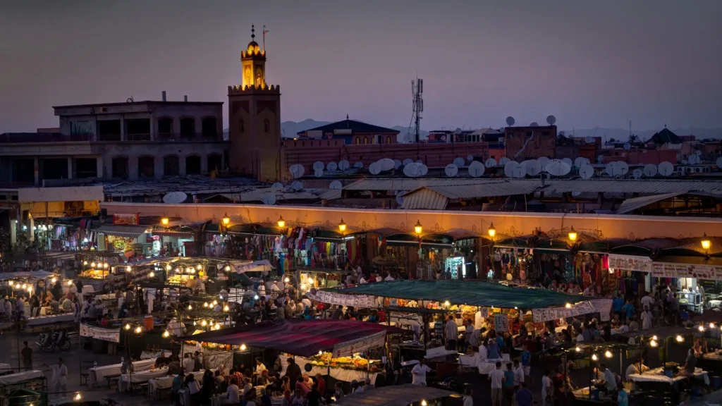 A bustling scene of Marrakech's city center, showcasing the vibrant culture and architecture of Morocco's red city.