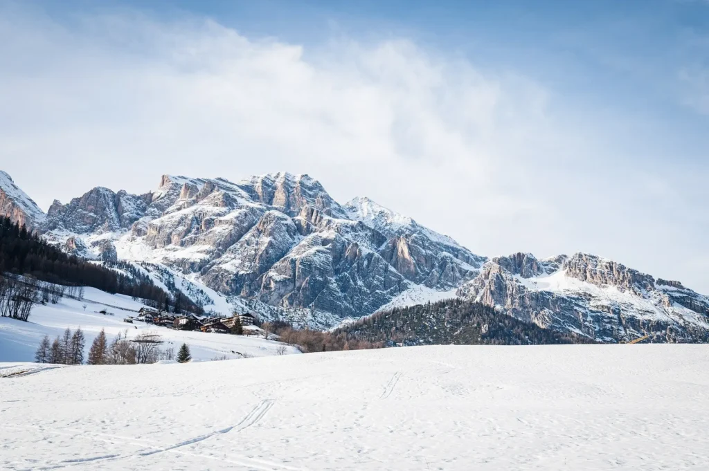  Majestic snow-covered mountain peaks under a clear blue sky, representing ideal February travel destinations in the USA.