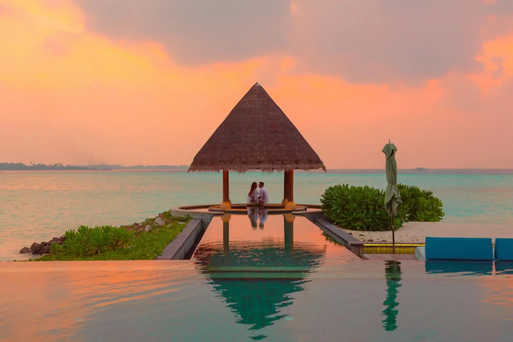 "Couple on a romantic beach at sunset, representing top vacation destinations for couples.