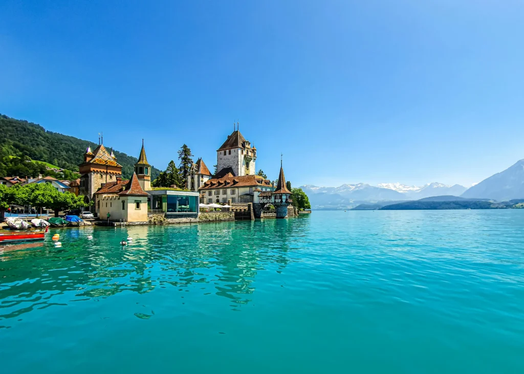 Scenic view of coastal buildings near a calm body of water, perfect for winter travel in February