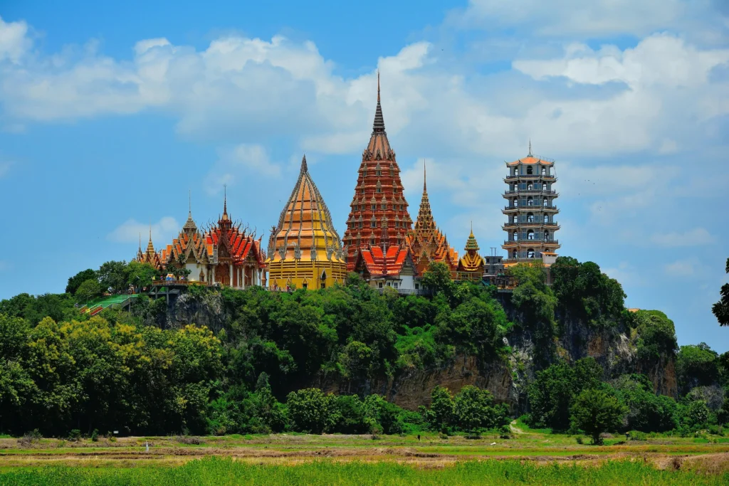 Blue and beige pagoda tower surrounded by lush greenery in Thailand, a top destination to visit in February