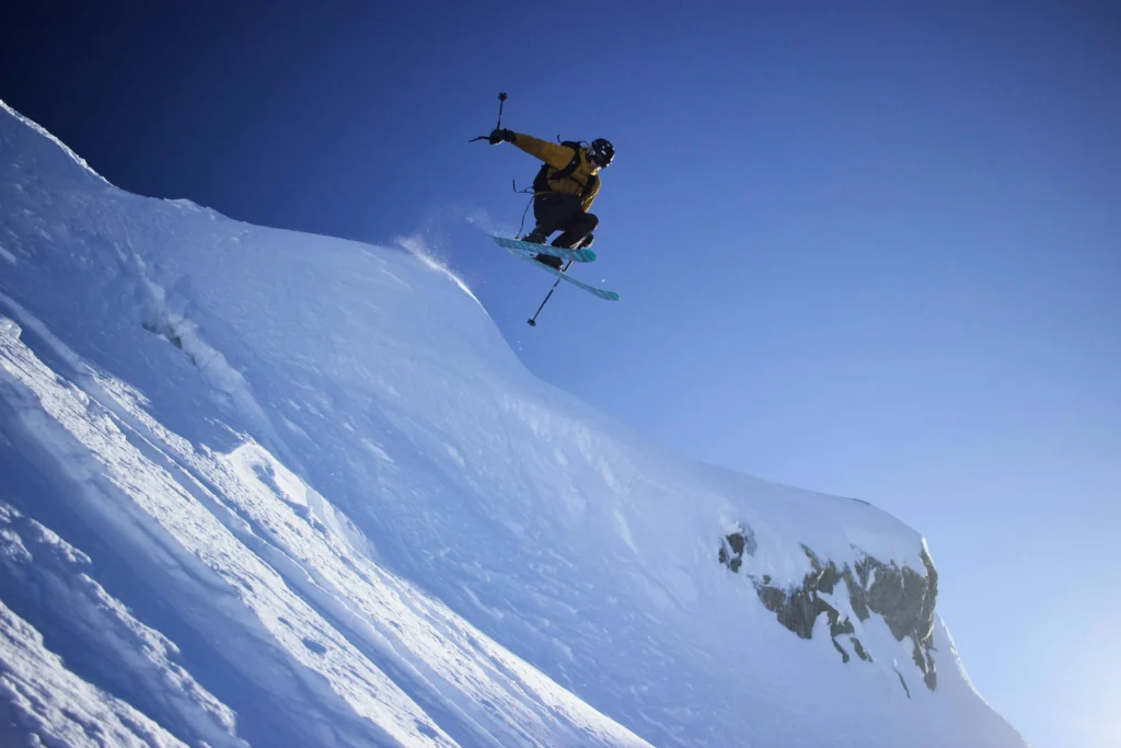 A man skiing down a snow-covered mountain slope in Whistler, British Columbia, Canada.