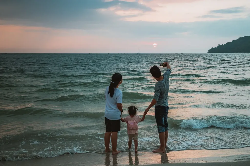 "Happy family enjoying a selfie at a beach resort, perfect for the best family resorts in Florida."

