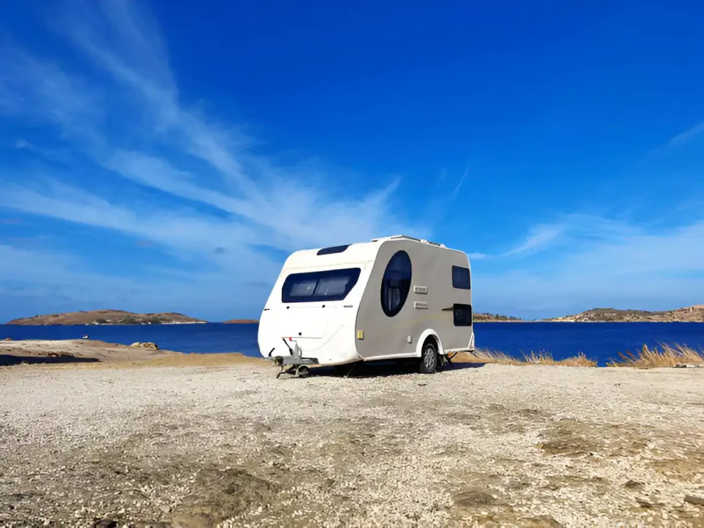 "Best travel trailers parked at a sunny seaside, showcasing top models for road trips and camping."