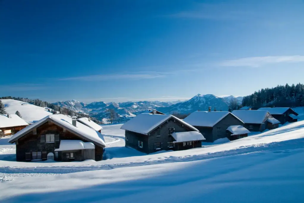 Scenic view of Sage Ski Lodge in Montana, surrounded by snow-capped mountains and evergreen forests, making it one of the best places to stay in Montana for a winter retreat.