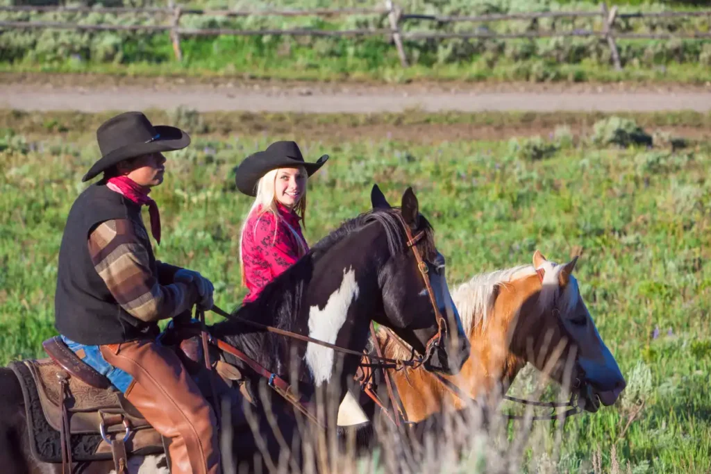 Two horseback riders exploring the scenic trails of Lone Mountain Ranch, one of the best places to stay in Montana for an authentic Western adventure.