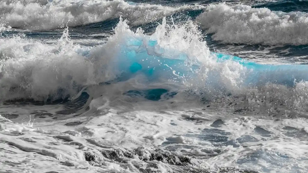 Waves crashing onto a sandy beach, embodying the essence of beach aesthetic.