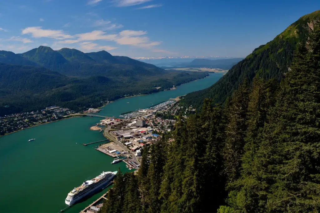 "Panoramic view of downtown Juneau, Alaska, showcasing its historic architecture nestled between Mount Juneau and Mount Roberts."

