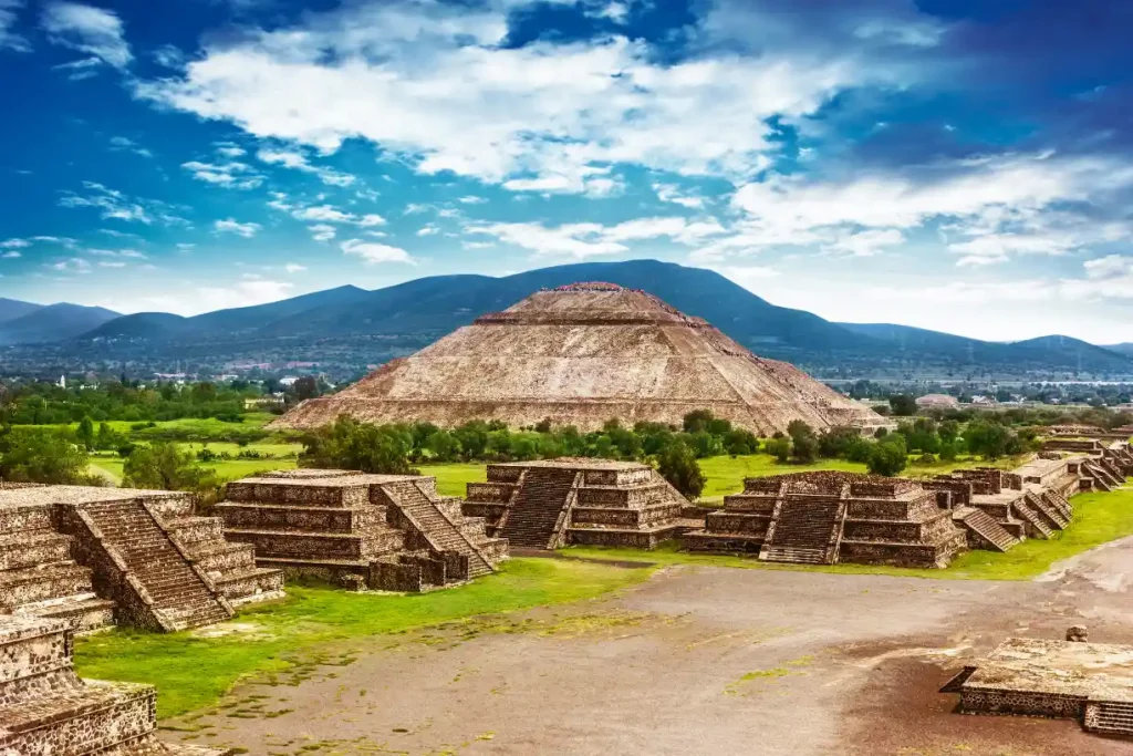 Ancient pyramids of Mexico under a clear blue sky, showcasing the rich history and culture of one of the cheapest places to visit in 2025 for budget travelers.

