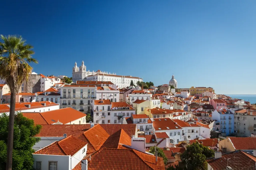 A stunning view of Lisbon, Portugal, one of the cheapest places to visit in 2025, featuring colorful buildings, historic architecture, and a scenic cityscape.

