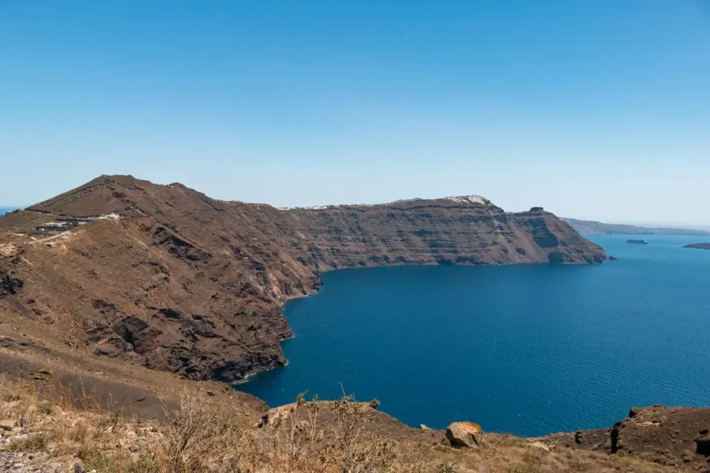 Stunning view of the Santorini caldera in Santorini Greece, featuring white-washed buildings perched on cliffs overlooking the deep blue Aegean Sea.