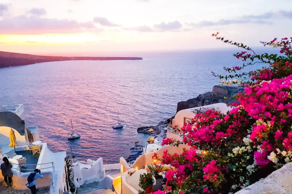 Breathtaking sunset over Santorini Greece, showcasing the iconic white-washed buildings and the deep blue Aegean Sea.