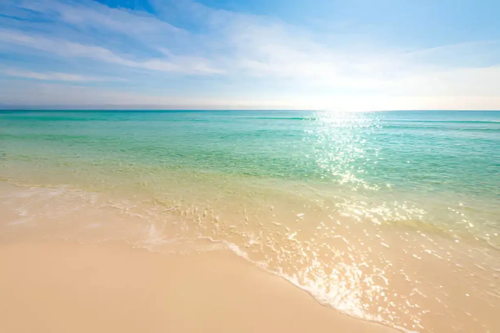 "Shiny glitter waves with sun reflections on the Gulf of Mexico, showing Destin water temperature and the crystal-clear waters of Destin, Florida."