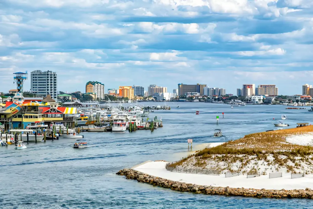 A scenic waterfront view near Big Kahuna Water Park Destin, showcasing boats, resorts, and a beautiful skyline.