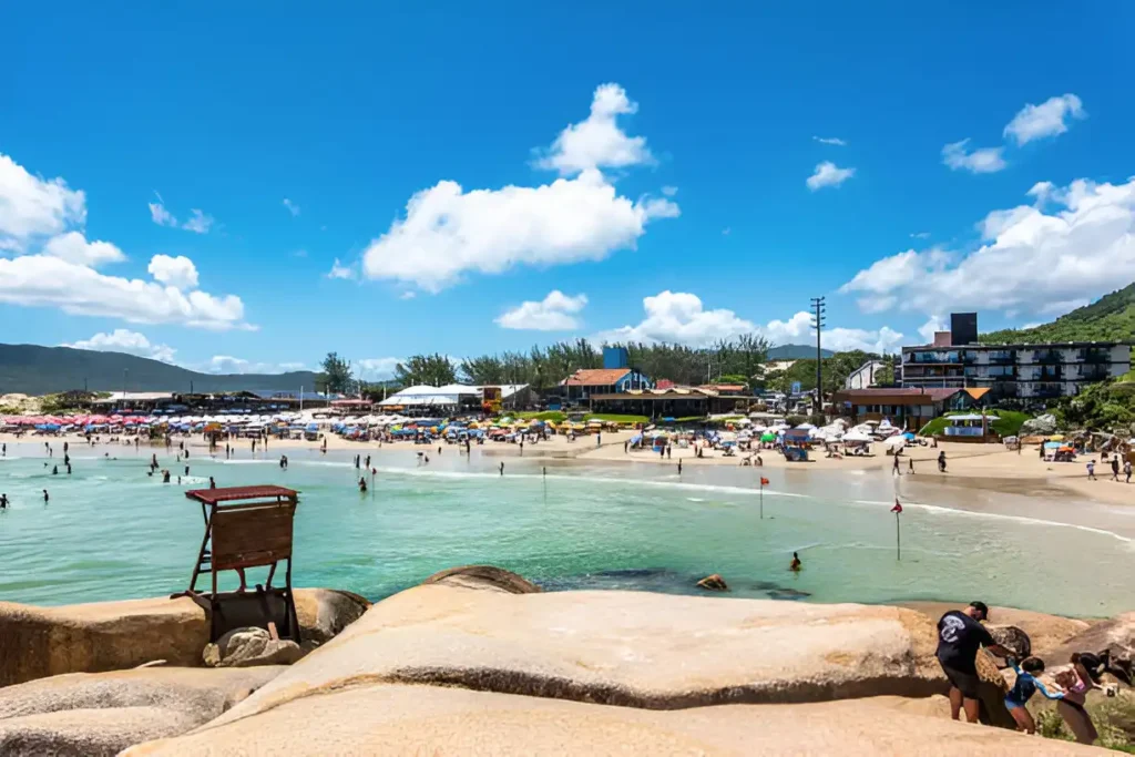 "Joaquina Beach in Florianópolis, Brazil, showcasing its stunning coastline, perfect for surfing and sunbathing, as part of the best travel itineraries for South America."