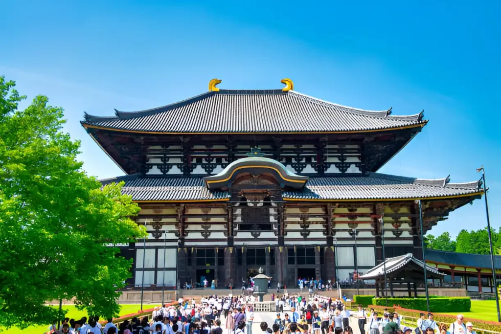 "Japan Travel Itinerary 10 Days: Tourists exploring Todai-ji Temple's Great Buddha Hall in Nara, Japan."