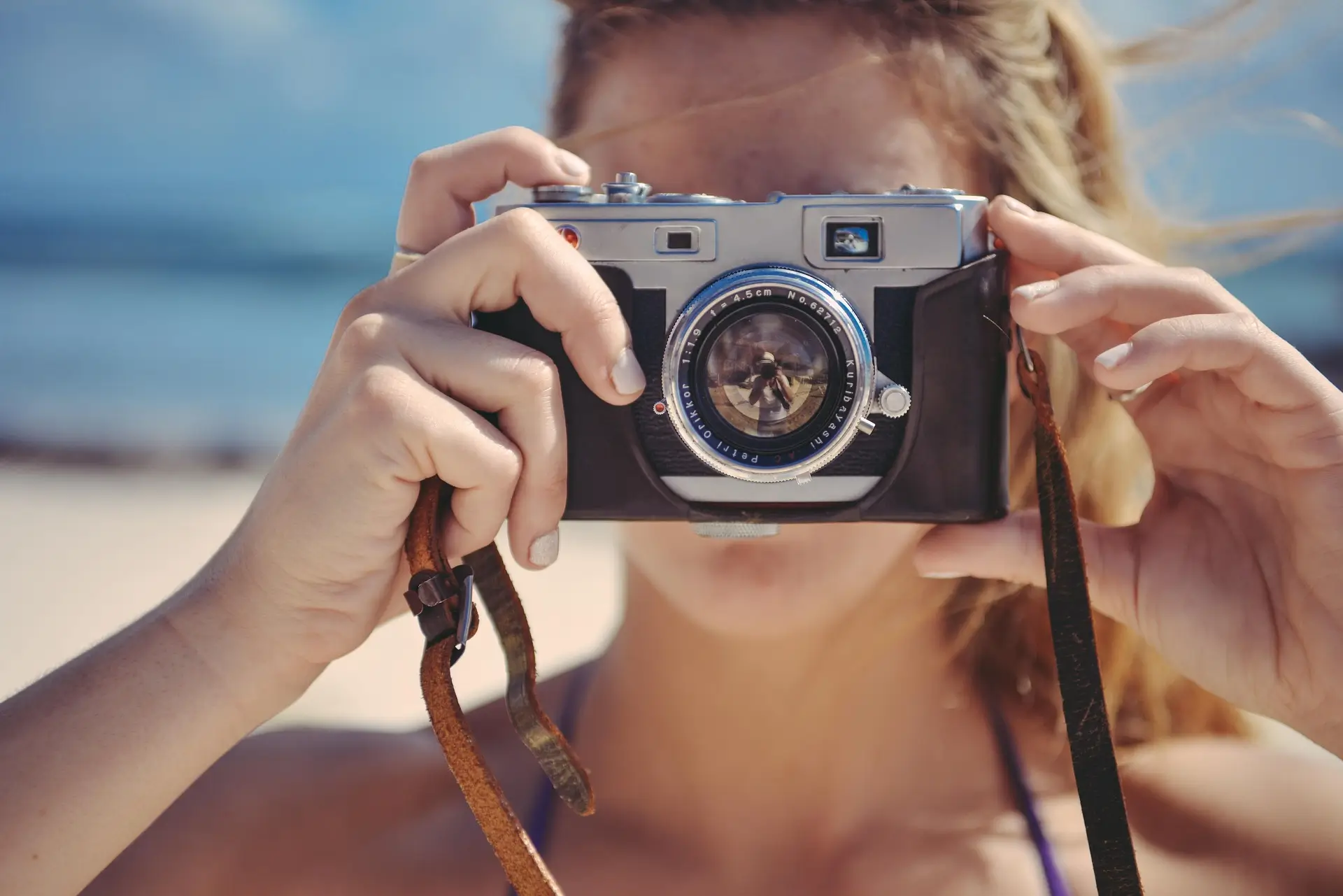 "A girl holding a camera, ready to capture stunning moments with the best camera for travel Asia."