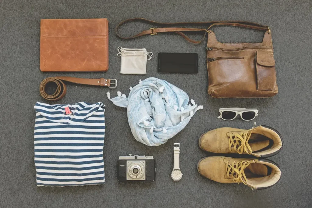 Flat lay of travel essentials, including fast-drying clothes, shoes, and accessories, ideal for packing light. Best Travel Fast Drying Clothes for Asia.