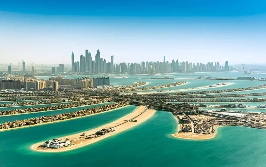 "Stunning aerial view of Palm Jumeirah, one of the best places to travel with friends in Dubai, showcasing its unique palm-shaped design and luxurious resorts."

