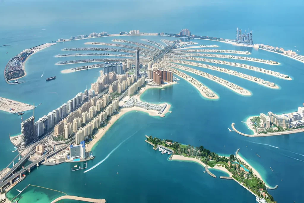 Aerial view of Palm Jumeirah, one of the best places to travel with friends in Dubai, showcasing its unique palm-shaped design and luxurious resorts.

