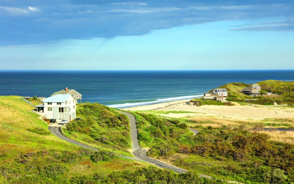 Scenic coastal view of Cape Cod, Massachusetts with beach houses and ocean, one of the best places to visit in August USA.