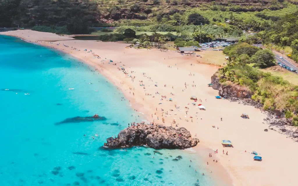 Aerial view of Waimea Bay’s turquoise waters and golden sands, showcasing one of the best beaches in Oahu.