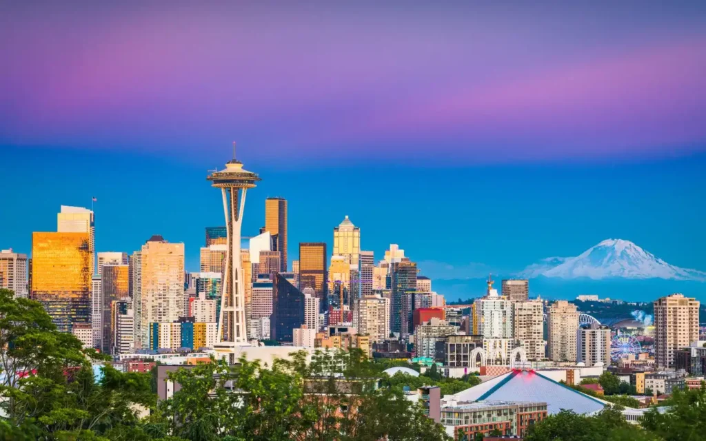 Colorful view of downtown Seattle, Washington with Mount Rainier in the background — one of the best places to visit in August USA.